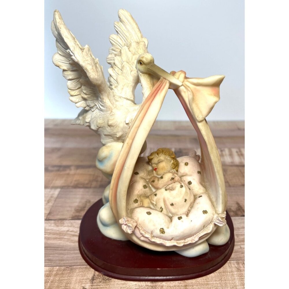 Vintage Stork And Baby Figurine With Detailed Accents On Wooden Base